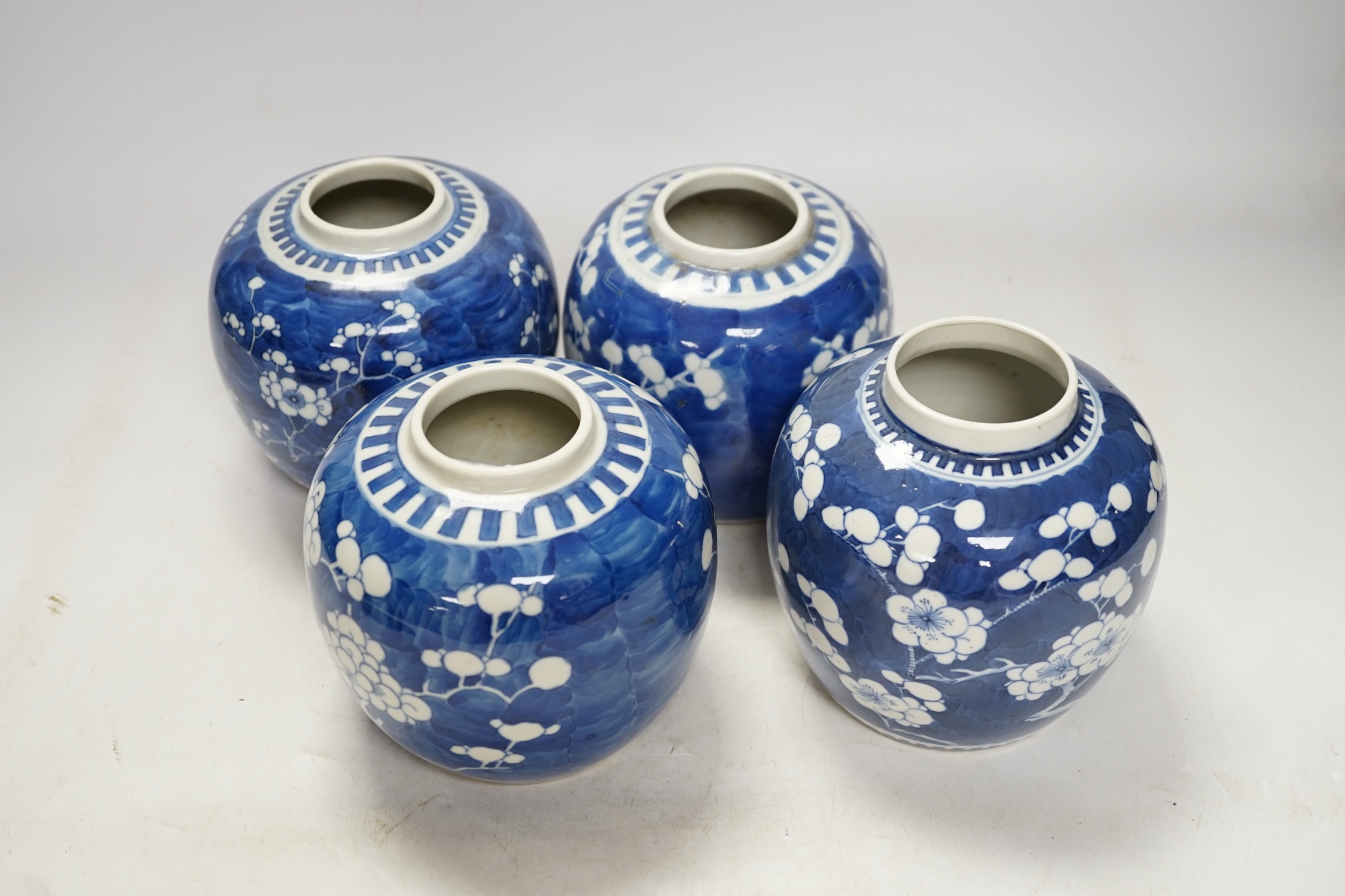 Four Chinese blue and white prunus jars (without covers), tallest 13.5cm. Condition - good